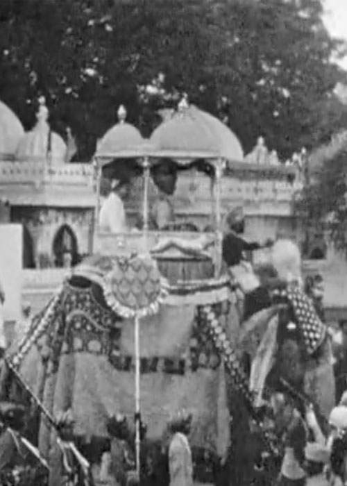 The Prince of Kutch riding on an ornately decorated elephant.